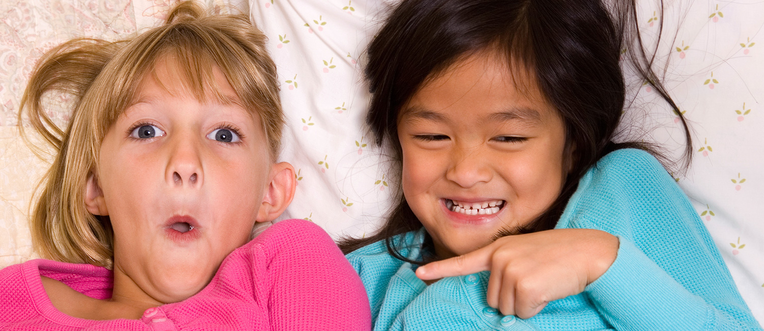  Two young girls at their first sleepover slumber party. 